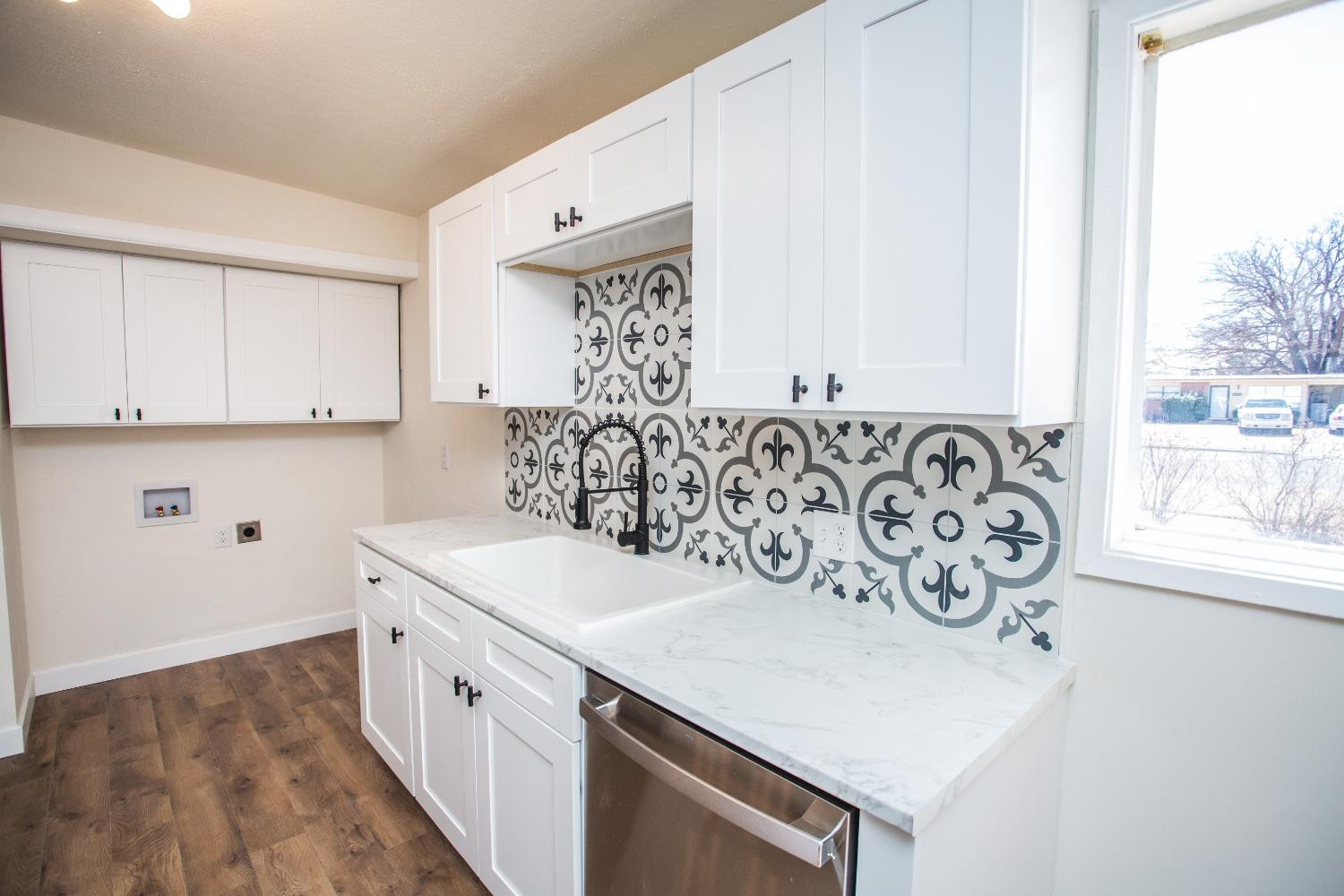 2728 66th Street Lubbock, TX 79413 - Photo 5 of 22 a view of kitchen with white cabinets