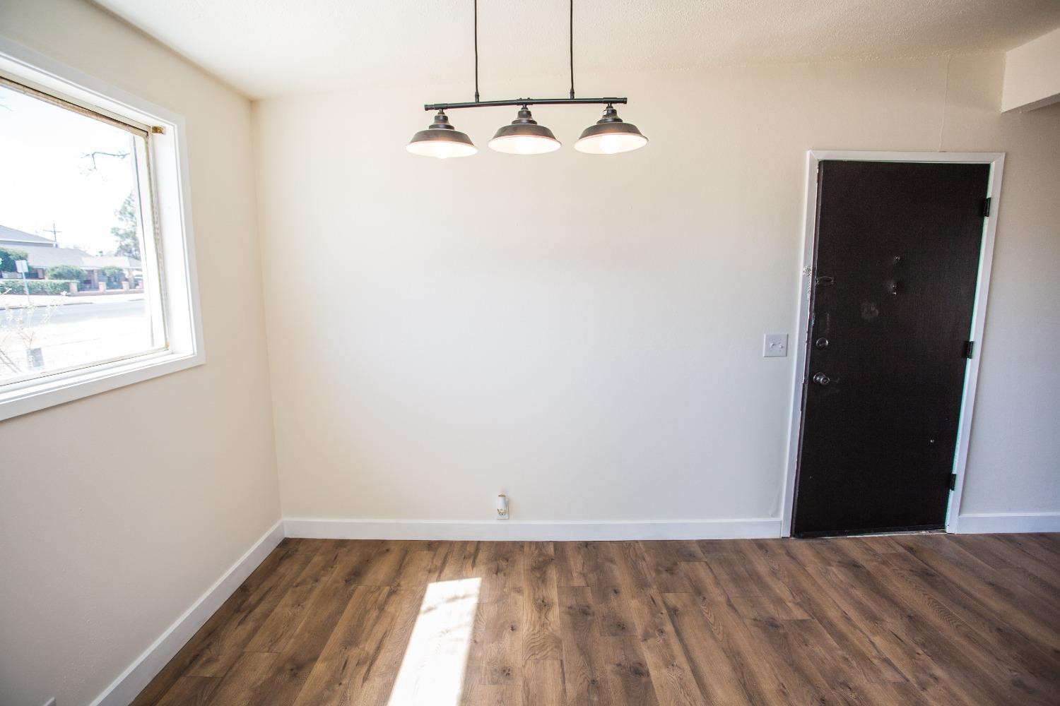 2728 66th Street Lubbock, TX 79413 - Photo 8 of 22 a view of a room with wooden floor and window