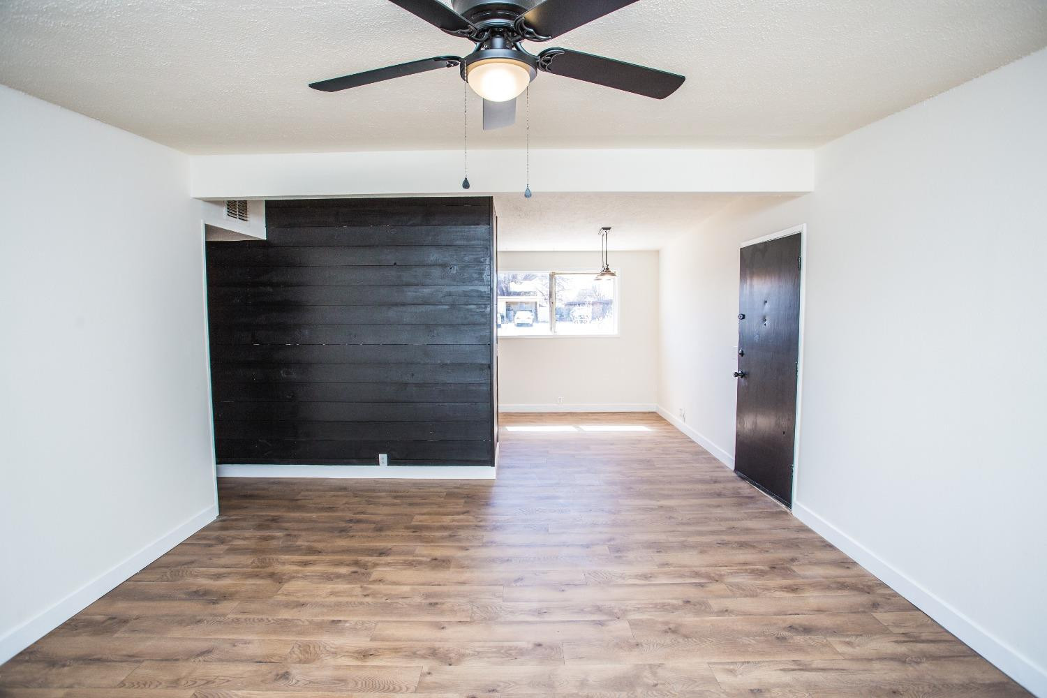 2728 66th Street Lubbock, TX 79413 - Photo 10 of 22 wooden floor in an empty room with a window