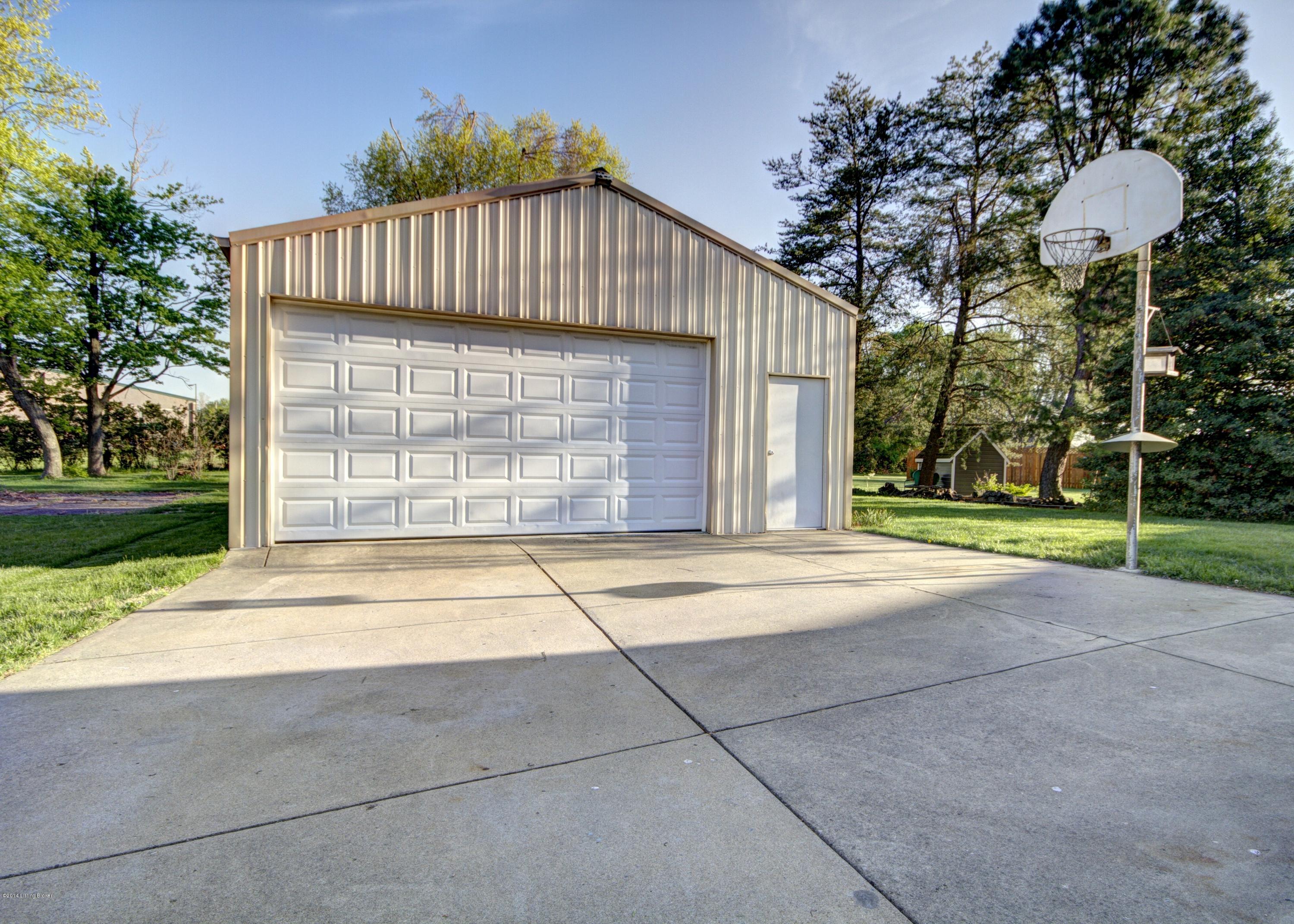 7602 Tempsclair Road Louisville, KY 40220 - Photo 4 of 44 ' MAN CAVE' !! 24' X 32' garage has 9' door, & 220 electric. Holds 4 cars.