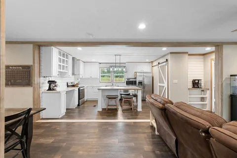 a large kitchen with a table and chairs in it
