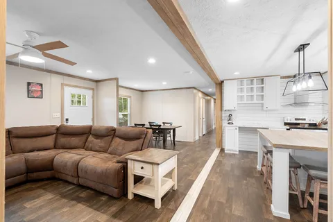 a living room with furniture and kitchen view