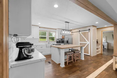 a kitchen with a sink a window and stainless steel appliances