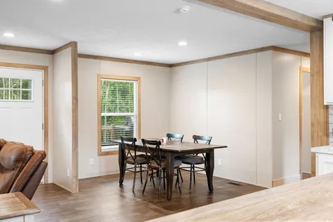 a view of a dining room with furniture window and wooden floor