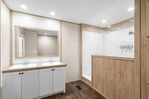 a bathroom with a double vanity sink and a mirror