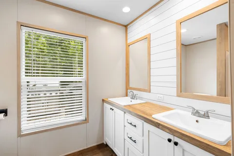 a bathroom with a sink a vanity and a mirror