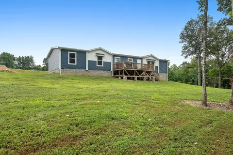 a house view with a sitting space and garden