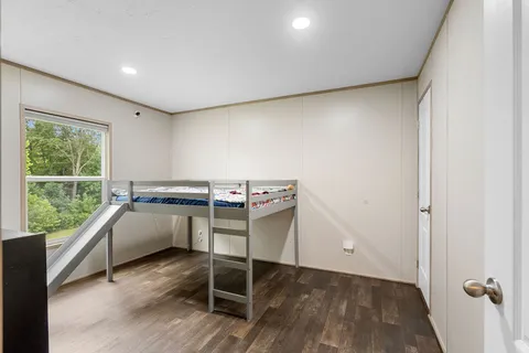 a room with a wooden floor and furniture