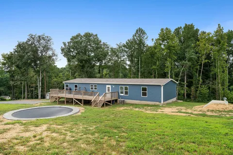 a swimming pool with outdoor seating and yard