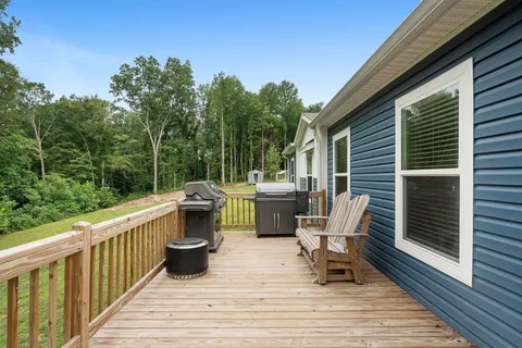 a view of a deck with chair and wooden floor