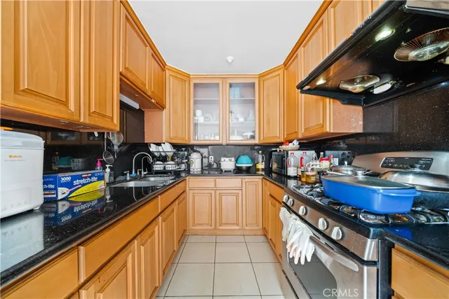 a kitchen with stainless steel appliances a sink a stove and cabinets