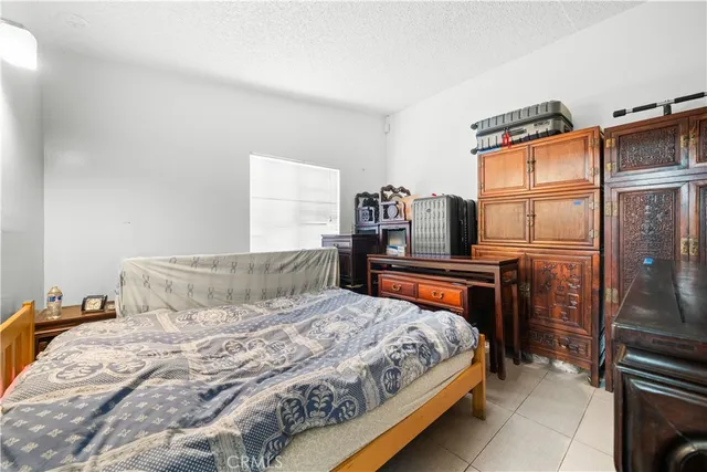 a bedroom with a bed and a window with balcony view