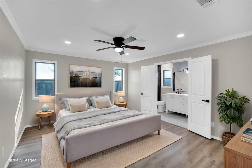 221 North Edgefield Road Waxahachie, TX 75165 - Photo 12 of 27 a bedroom with a large bed and a chandelier fan