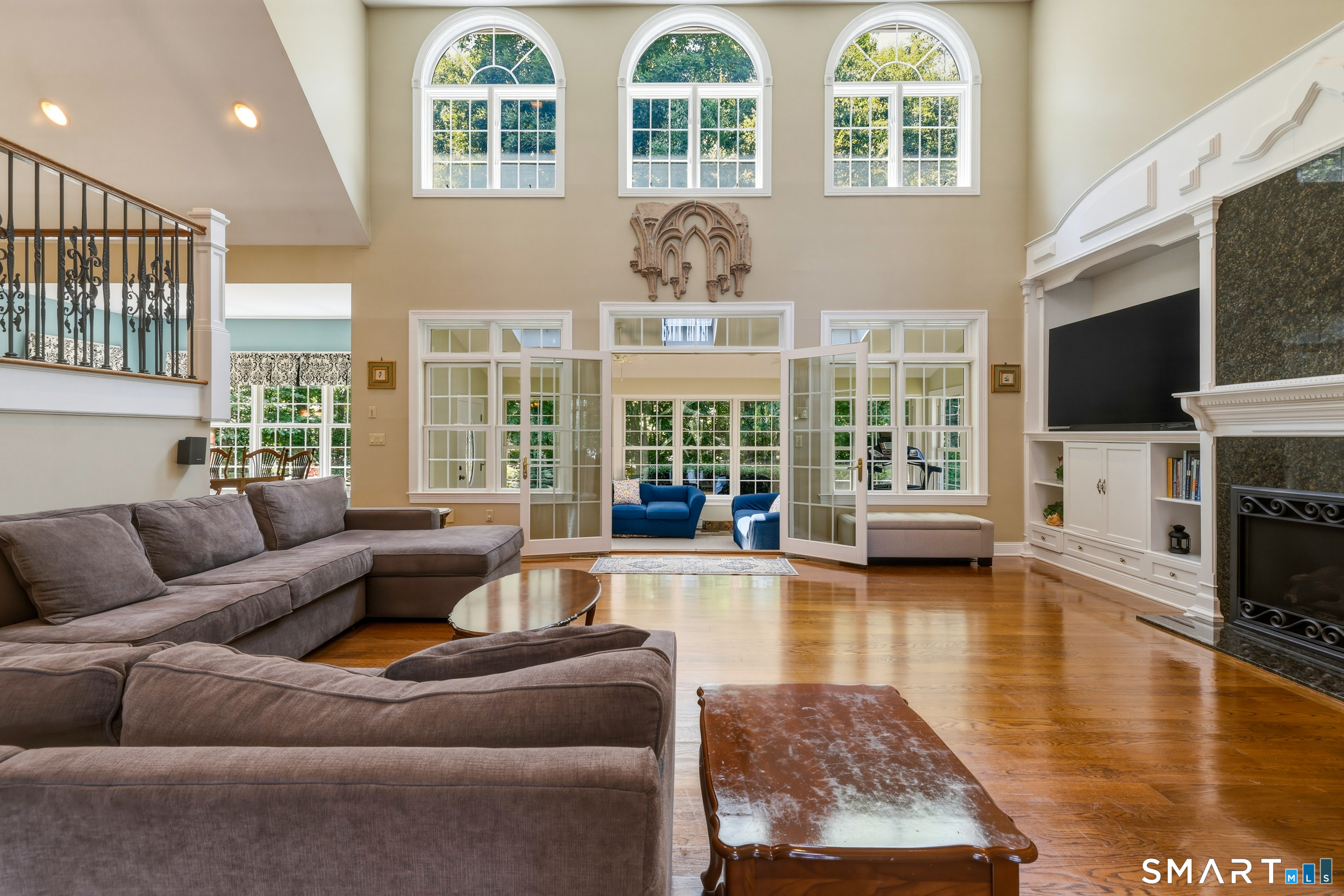 122 Lower Road Guilford, CT 06437 - Photo 9 of 40 The dramatic family room features walls of glass and Palladium windows, filling the space with natural light throughout the day. A second-floor balcony overlooks both the family room and foyer, while custom built-ins adds function and style.