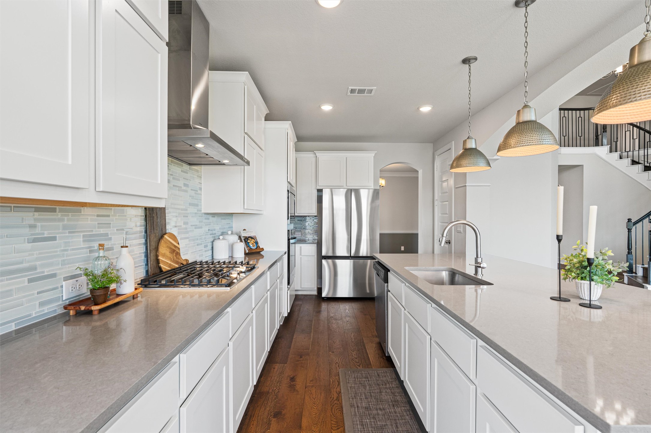 108 Rio Vista Drive Georgetown, TX 78626 - Photo 14 of 40 a kitchen with stainless steel appliances kitchen island granite countertop a sink a stove and a wooden floors