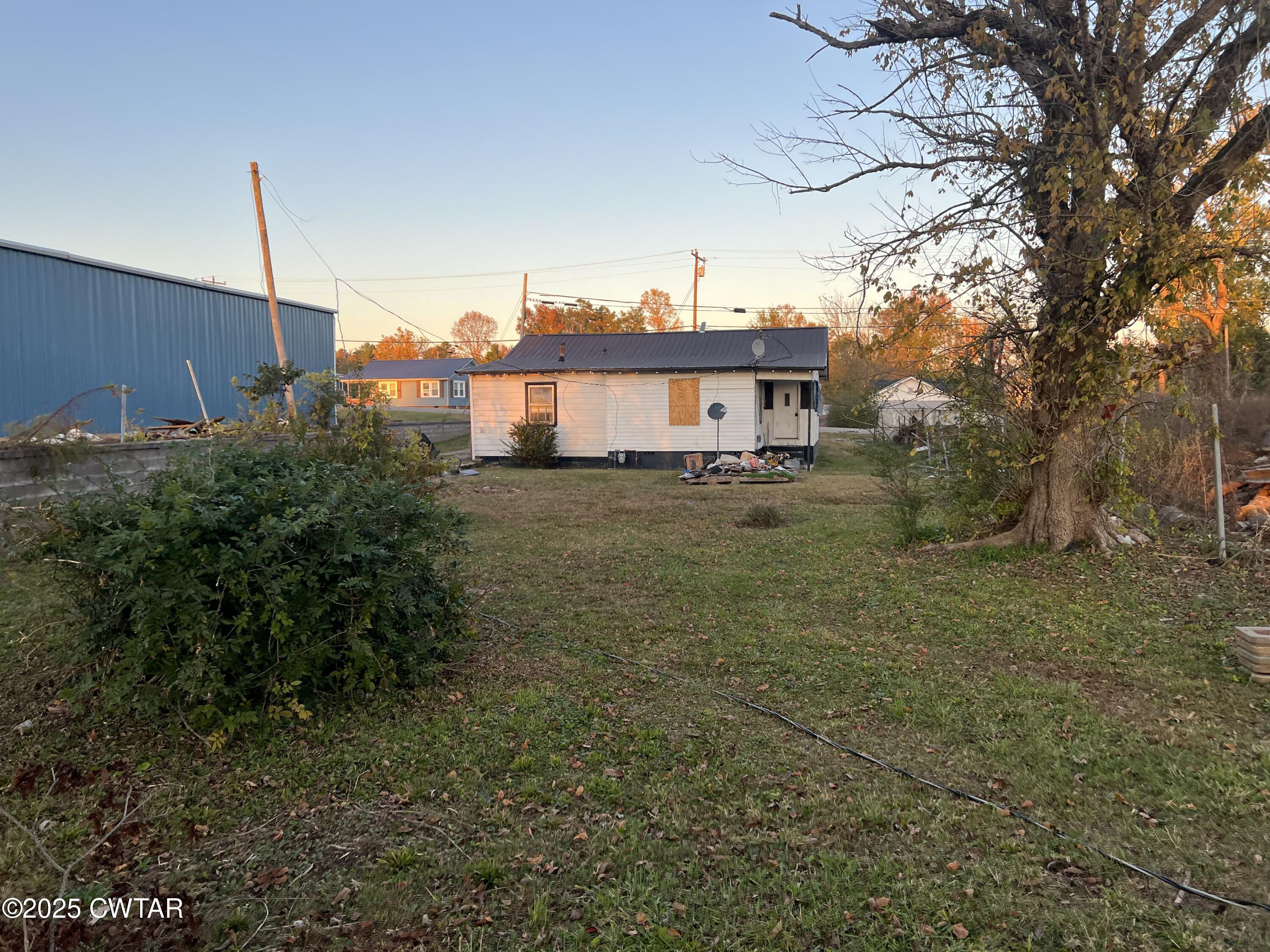 464 Peach Street Selmer, TN 38375 - Photo 2 of 4 a view of a house with a yard