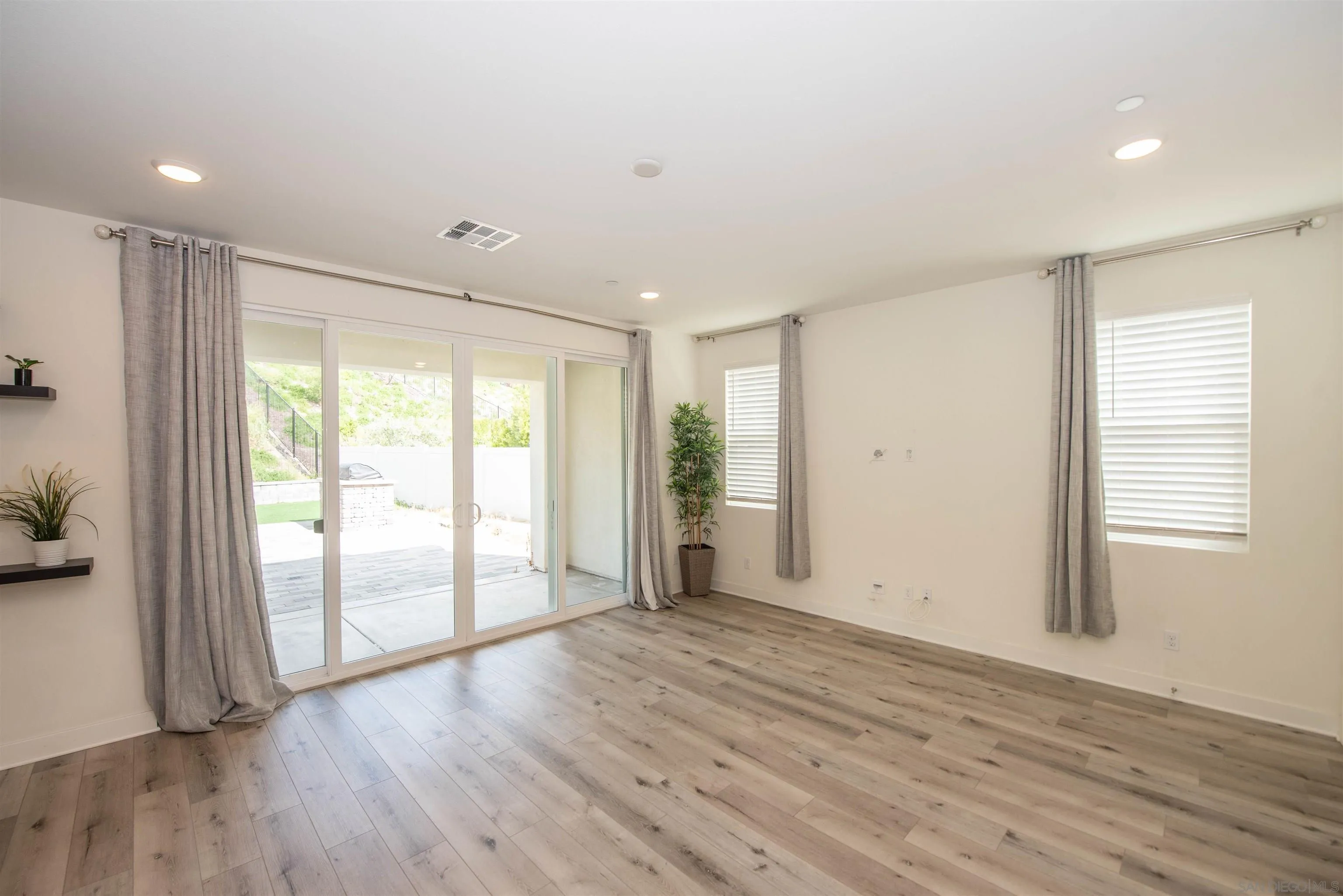 8902 Trailridge Avenue Santee, CA 92071 - Photo 12 of 38 a view of an empty room with wooden floor and a window
