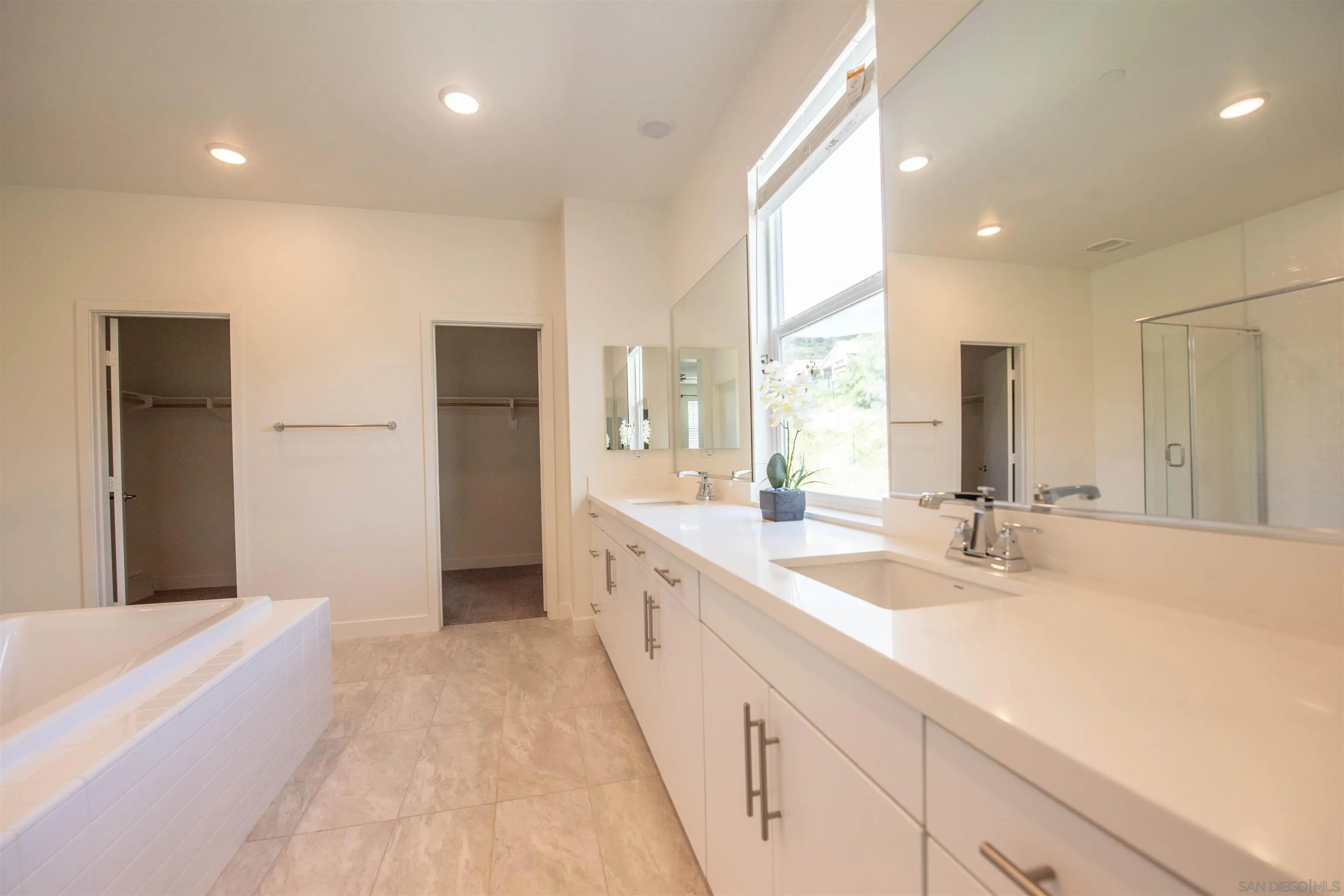8902 Trailridge Avenue Santee, CA 92071 - Photo 16 of 38 a spacious bathroom with a double vanity sink a mirror and a bathtub