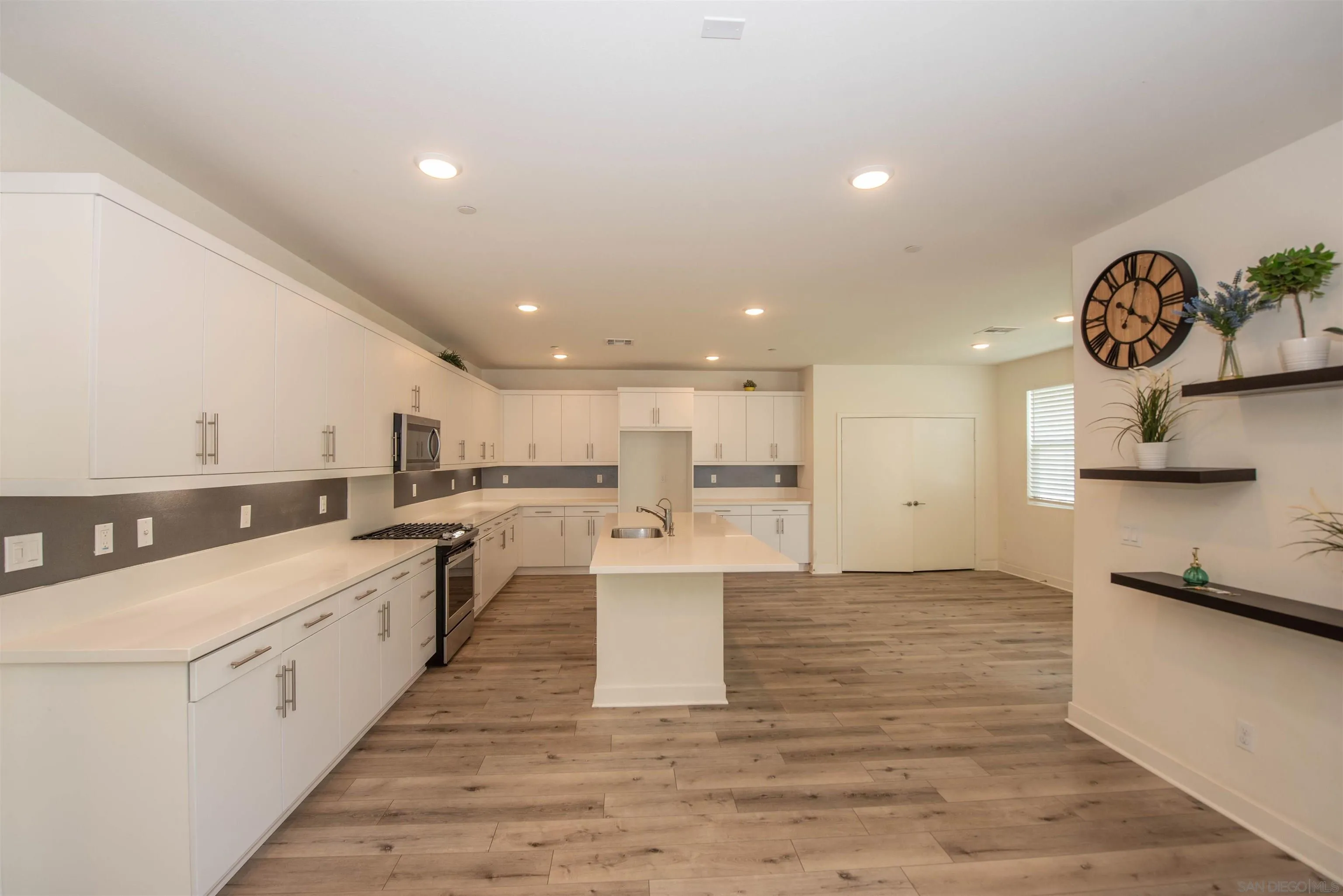 8902 Trailridge Avenue Santee, CA 92071 - Photo 2 of 38 a kitchen with a sink cabinets and wooden floor