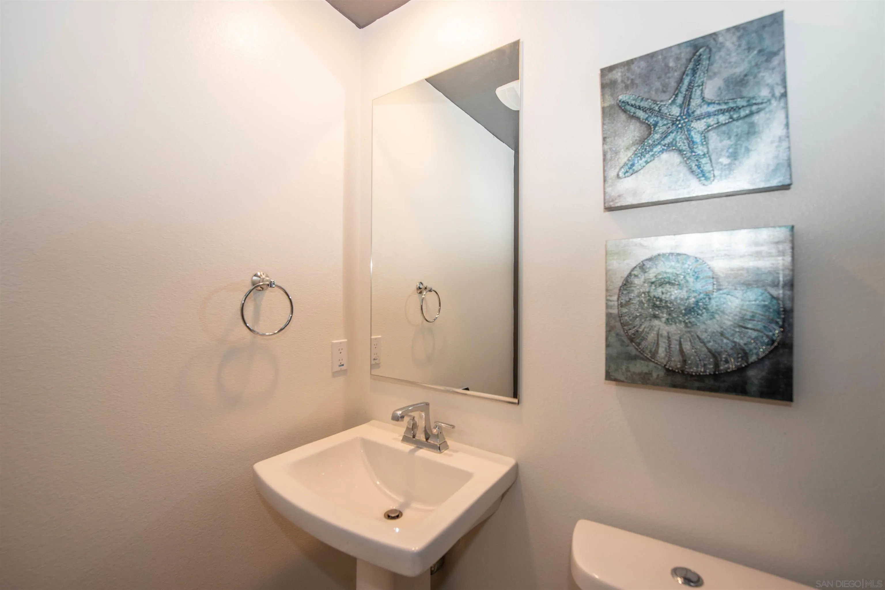 8902 Trailridge Avenue Santee, CA 92071 - Photo 25 of 38 a bathroom with a toilet a sink and mirror