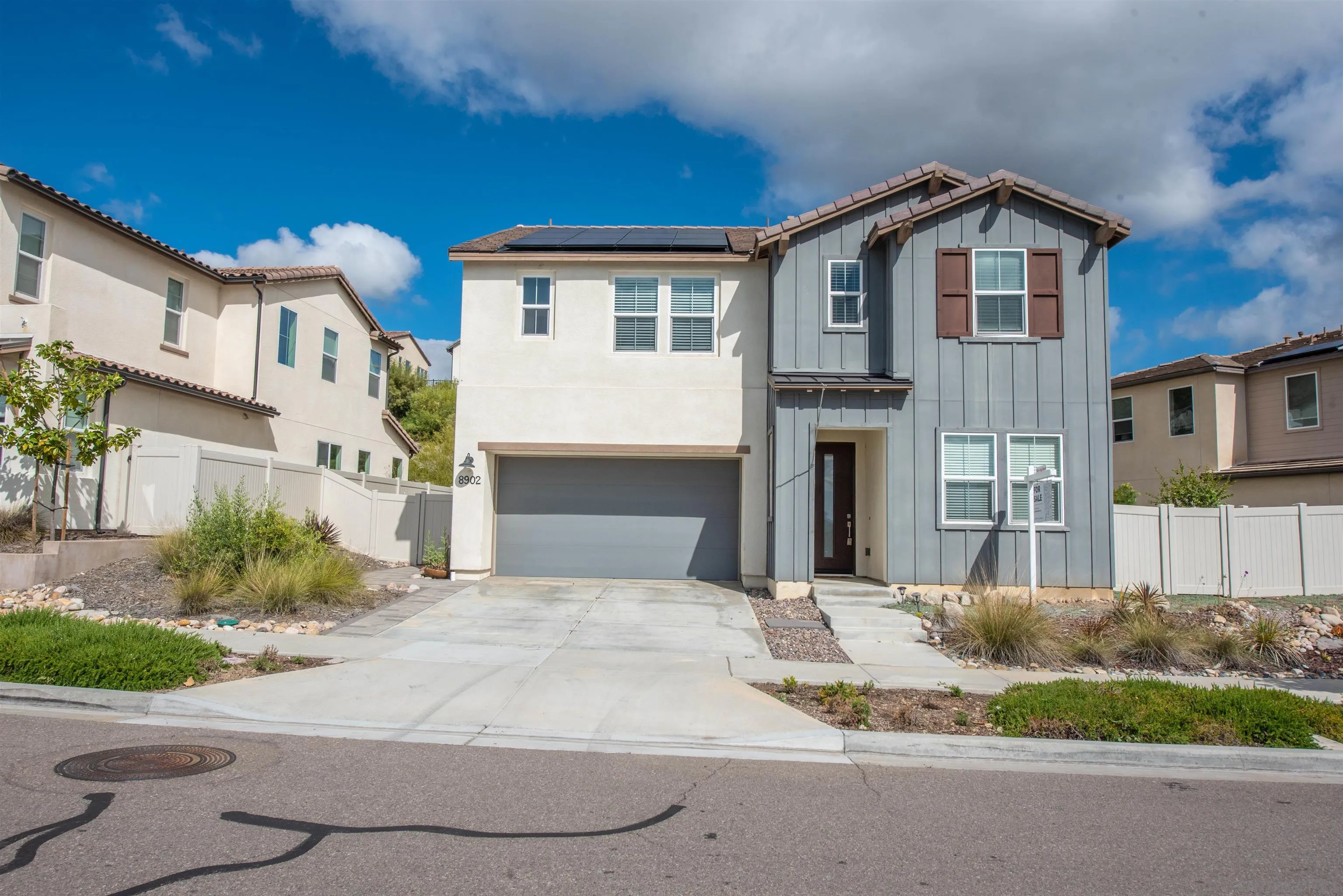 8902 Trailridge Avenue Santee, CA 92071 - Photo 32 of 38 a front view of a house with a yard and garage