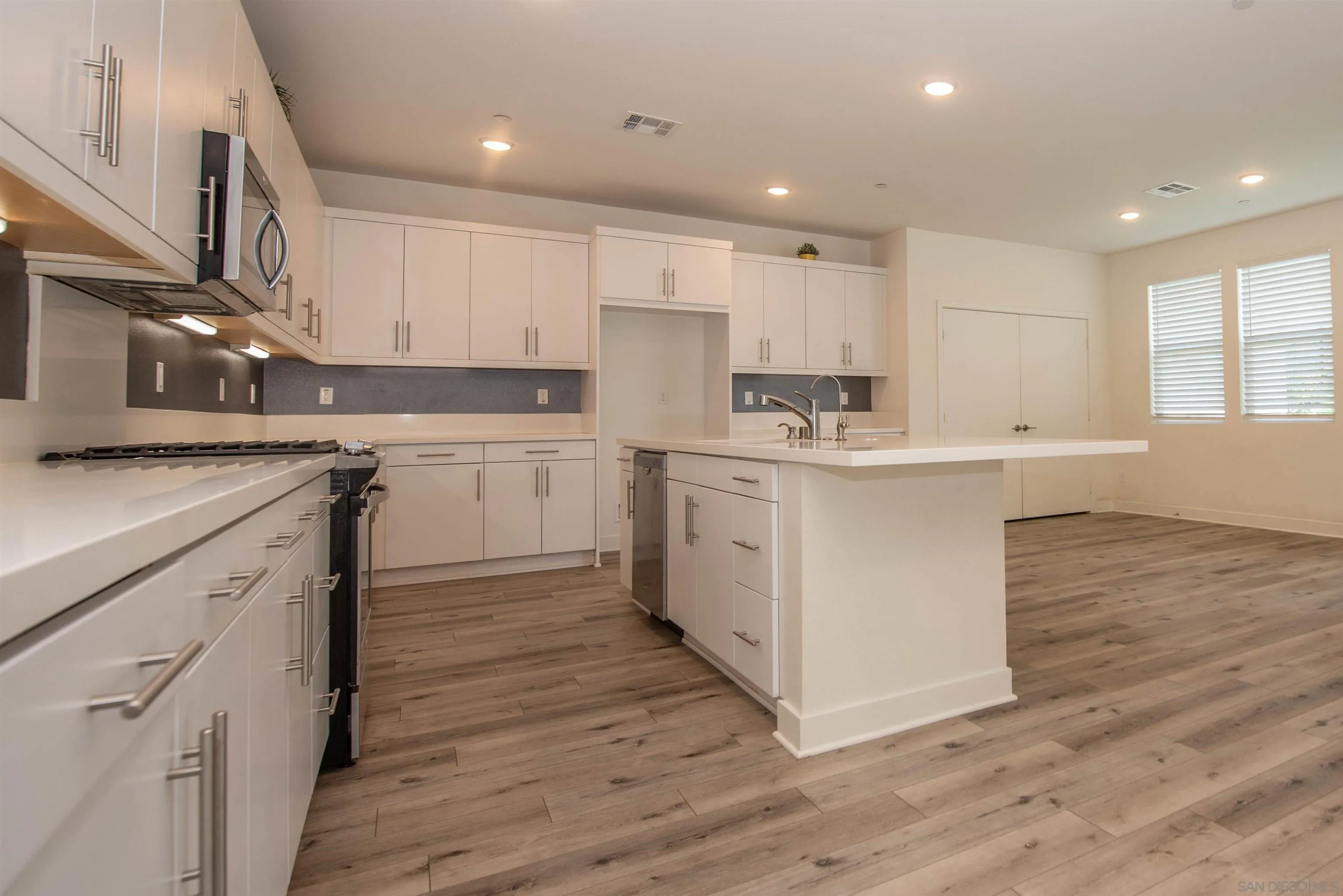 8902 Trailridge Avenue Santee, CA 92071 - Photo 7 of 38 a kitchen with a sink window and cabinets