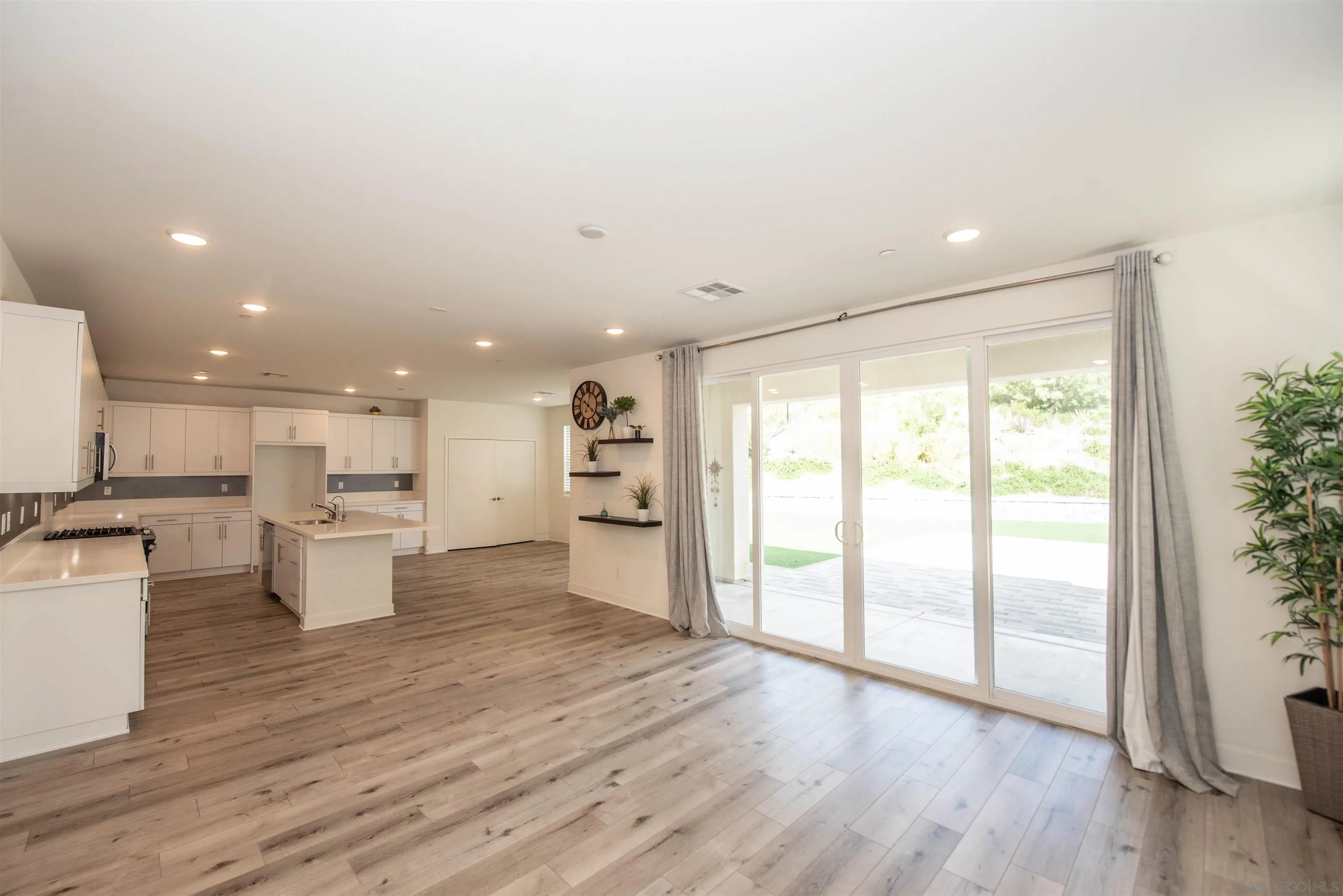 8902 Trailridge Avenue Santee, CA 92071 - Photo 9 of 38 a view of a kitchen with kitchen island wooden floor and stainless steel appliances
