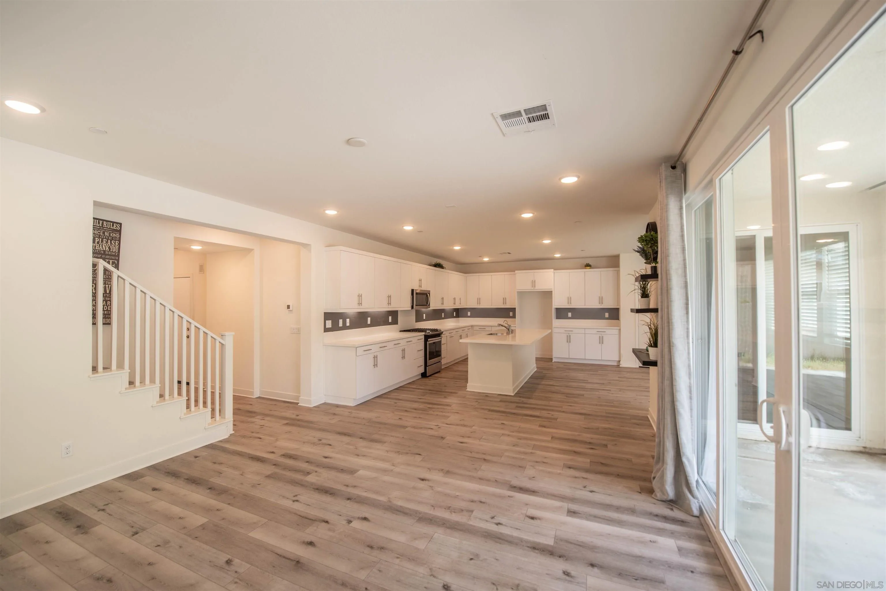 8902 Trailridge Avenue Santee, CA 92071 - Photo 10 of 38 a view of kitchen dining table chairs microwave and cabinets