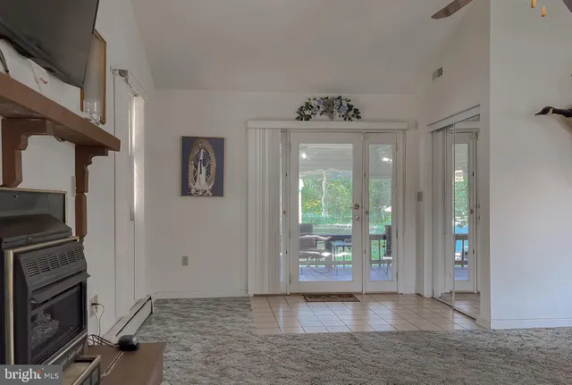 a view of a dining room with furniture and chandelier
