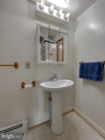 a bedroom with a bed and a flat tv screen on dresser