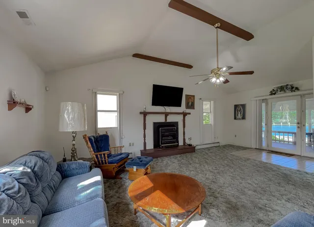 a bedroom with a bed and a flat tv screen on dresser