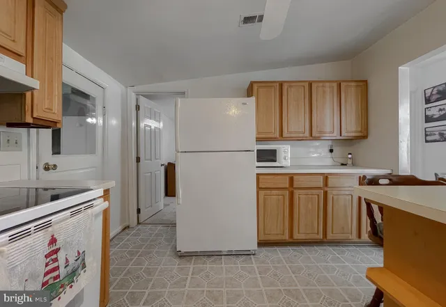 a front view of a house with a yard and potted plants