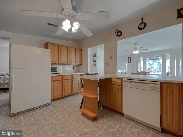 a view of a balcony with chairs and wooden floor