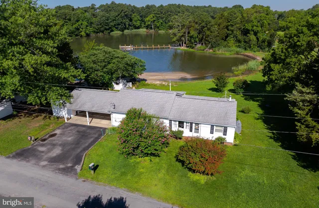 an aerial view of lake residential house with swimming pool and outdoor space