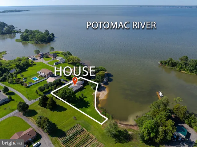an aerial view of a house with a yard swimming pool and outdoor seating