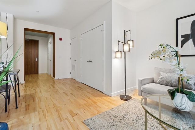 a bedroom with furniture and a rug