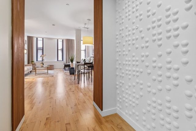 wooden floor with a view of living room