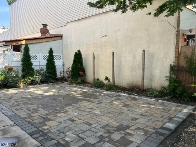 a front view of a house with plants