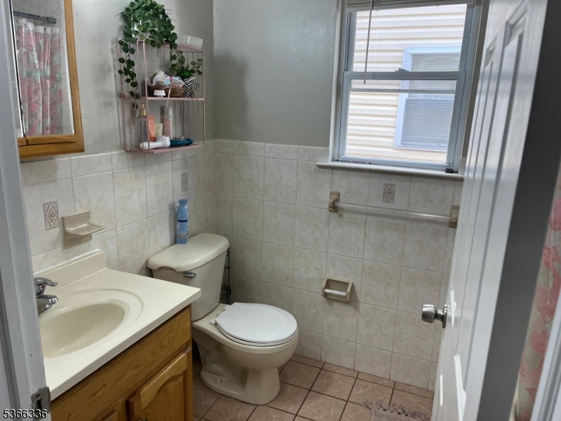 27 Camp Street, Unit 3 Newark, NJ 07102 - Photo 16 of 23 a bathroom with a sink toilet and window