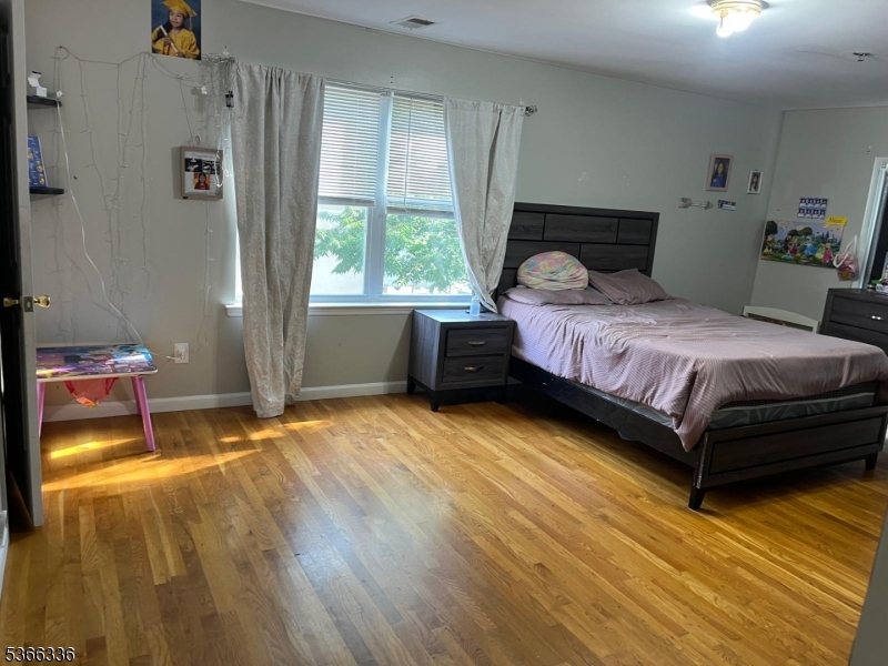 27 Camp Street, Unit 3 Newark, NJ 07102 - Photo 6 of 23 a bedroom with a bed and a window