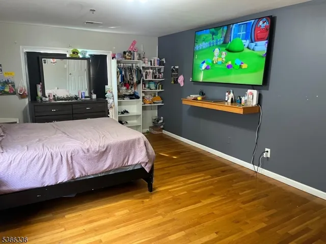 a room with wooden floor and furniture