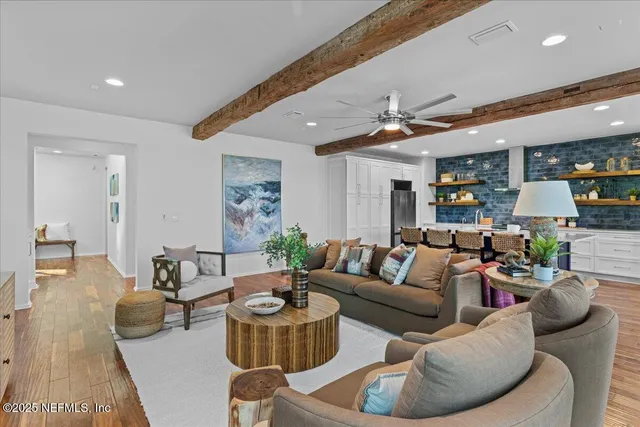 a living room with furniture and a potted plant