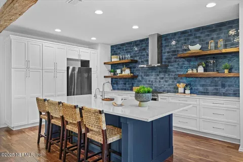 a bathroom with a granite countertop sink a mirror and shower