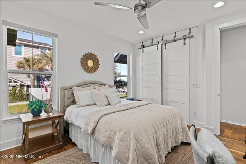 a bathroom with a granite countertop sink a mirror and a bathtub