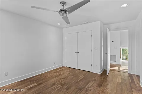 a view of a room with wooden floor and windows