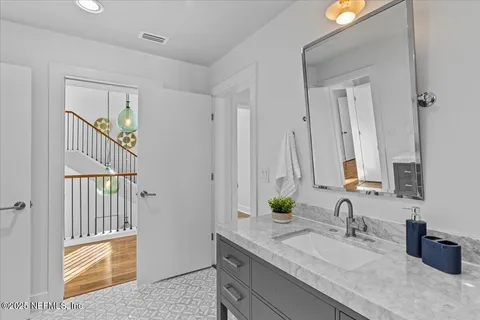 a view of house with garden and tall trees