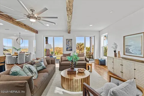 a living room with lots of furniture and a large window