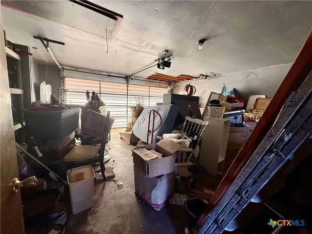 a view of walk in closet with clothes