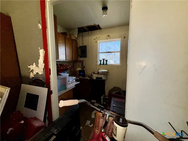 a view of workspace with mirror and window