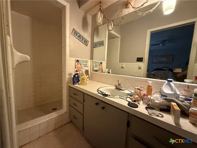 a bathroom with a sink double vanity and a mirror